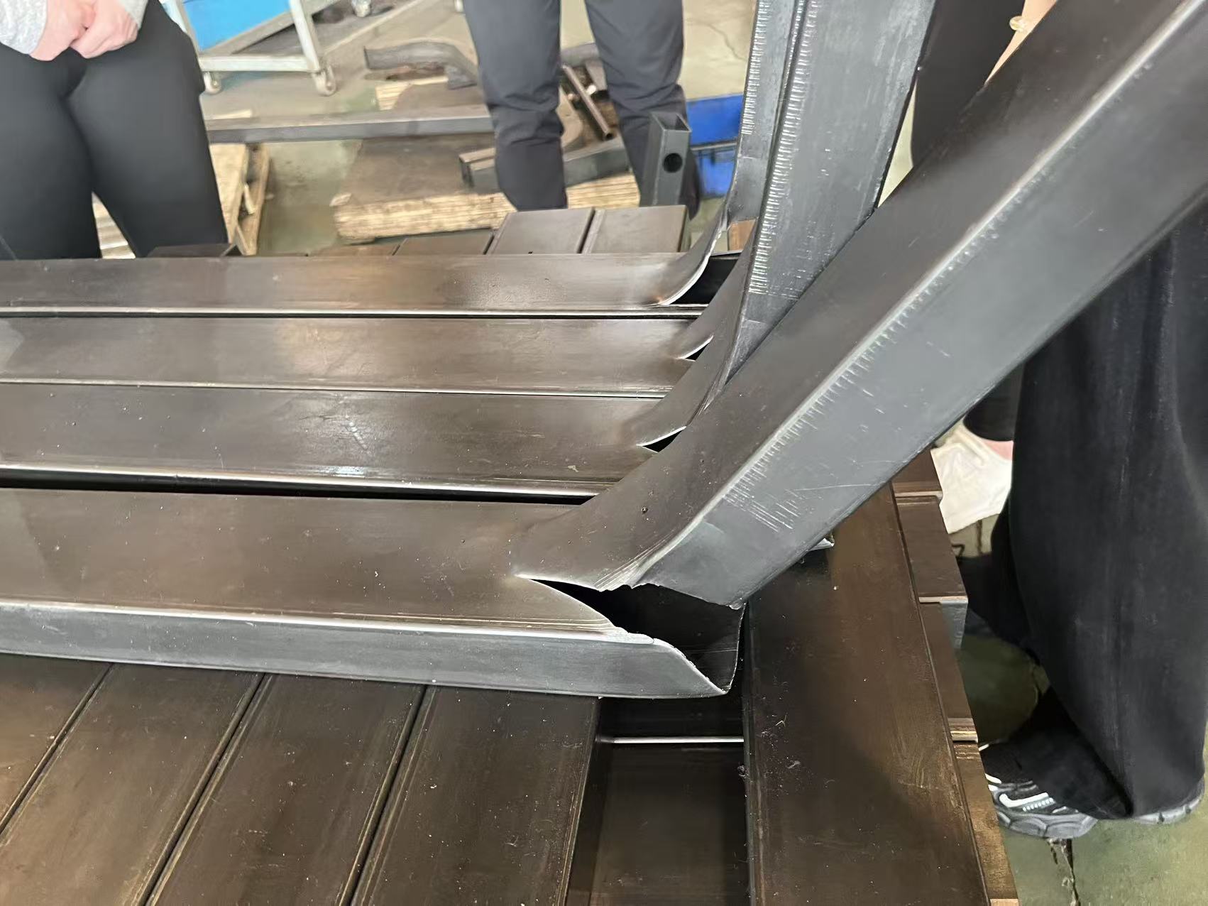 Standard 2mm thin-wall gym frame under heavy load showing deformation risk